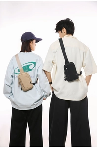 Close-up of black and khaki nylon crossbody chest bags showing adjustable wide straps