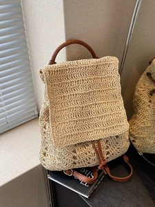 Straw woven backpack with leather straps and drawstring closure for summer fashion