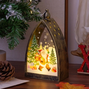 Vintage bronze Christmas lantern with Santa Claus illustration and warm LED lighting