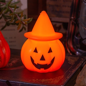 Glowing Halloween pumpkin lantern with wizard hat on vintage books for table decor