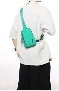 Detail view of the mint green nylon crossbody bag showing the adjustable shoulder strap and buckle