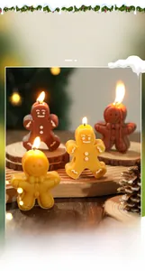 Close-up of lit gingerbread man scented candle with festive pine cones and holiday lights