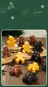 Detailed view of gingerbread man scented candles set for festive Christmas home decor