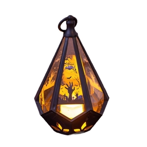 Halloween pumpkin lantern with diamond cut design and spooky graveyard silhouette