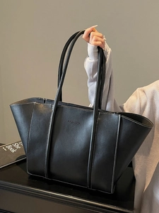 Black large leather tote bag with white contrast stitching and FASHION logo detail