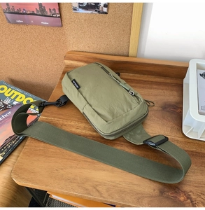 Detail of army green nylon crossbody bag with Leshajia woven label and adjustable strap
