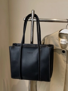 Black vintage leather tote bag with white contrast stitching and long shoulder straps