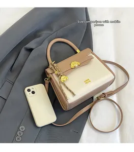 Size comparison of the vintage crossbody bag showing its compact dimensions with a phone