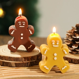 Christmas gingerbread man scented candles in brown and yellow for festive home decor