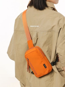 Vibrant orange nylon crossbody chest bag for women with adjustable strap on model