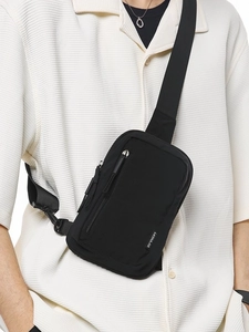 Minimalist black nylon crossbody bag for women with adjustable strap and logo detail