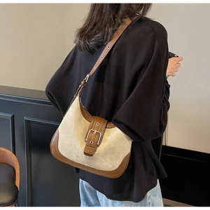Détail du sac hobo en tissu beige avec garniture en cuir marron contrastant