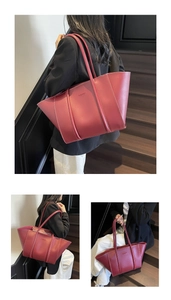 Detail view of burgundy tote bag with white contrast stitching and Fashion embossed logo