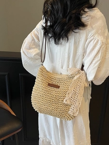 Large woven straw bucket bag with lace bow and leather strap for beach or daily wear
