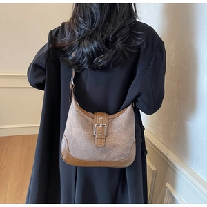 Détail du sac bandoulière croissant bicolore kaki et marron avec boucle métallique