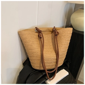 Woven straw tote bag with brown leather straps for women, perfect for spring vacation use