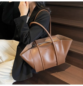 Detail of vintage brown tote bag with white contrast stitching and long shoulder straps