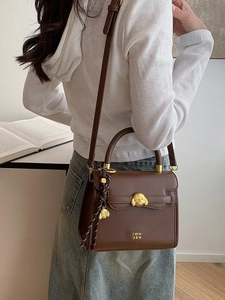 Retro brown leather crossbody bag with distinctive gold dog head hardware and top handle