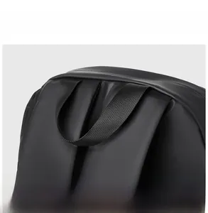 Close-up of a durable nylon handle and waterproof fabric texture on a black laptop backpack