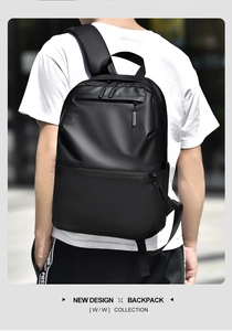 Waterproof black business backpack with padded straps shown worn in an outdoor city setting