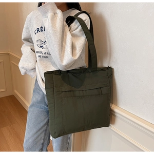 Detailed side view of an olive green large-capacity tote bag worn over the shoulder