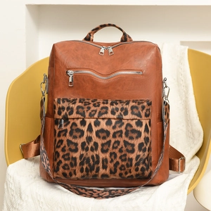 Macro shot of retro brown PU leather backpack with a leopard print front pocket