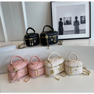 Detail of quilted cross body bags with gold chain straps and decorative star charms