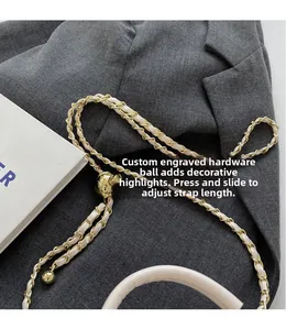 Detail of adjustable gold-tone metal ball on quilted faux leather woven chain strap