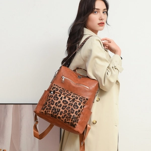 Detail of leopard print front pocket and textured brown faux leather on chic backpack