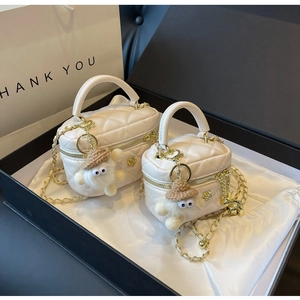 Quilted cream leather chain bags featuring golden rose logo and plush mascot in a gift box