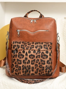 Brown faux leather leopard print backpack with multiple zippers and removable strap
