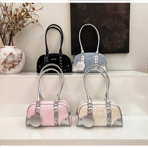Detail of Boston bags featuring marble-textured glossy leather and metal handles