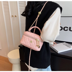 Pink quilted mini box bag with floral metal accent and star charm chain strap