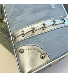 Detail of grey marble texture underarm bag with silver metallic trim and rivets