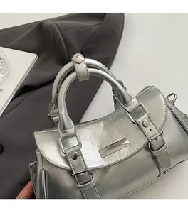 Detailed macro view of crinkled silver leather texture and metal buckle on the handbag