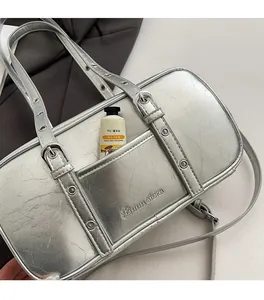 Detail view of silver Boston bag showing front pocket and interior storage depth