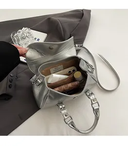 Detailed interior of a silver metallic Boston bag showing large capacity and inner pockets
