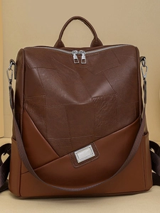 Zaino vintage in pelle marrone scuro con design patchwork, grande capacità e dettagli in argento