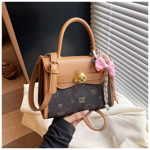 Dettaglio della borsa vintage con chiusura a cane dorata e nastro rosa