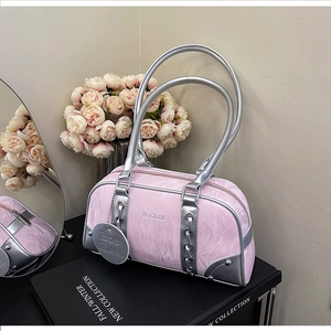 Detail of pink marble pattern Boston bag with silver accents on elegant books