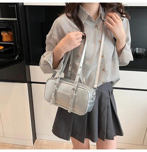 Close-up of silver Boston bag with vintage cracked leather texture and metallic eyelets