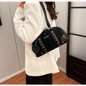 Shoulder bag detail featuring white BOCILEE logo and metallic eyelet lace-up accents