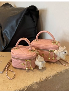 Pink quilted mini chain bag with plush monster charm on stone base, stylish shoulder bag