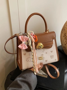 Borsa a tracolla vintage marrone e beige con stampe cartoon e chiusura cane in metallo
