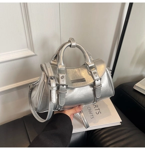 Detailed close-up of silver dumpling bag with metallic texture and buckle strap accents