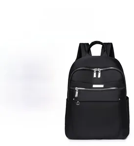 Detail of waterproof black nylon backpack with silver zippers and minimalist design