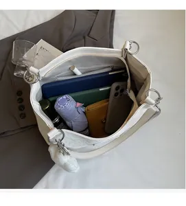 Detail showing white tote bag interior with large capacity for umbrella and tablet