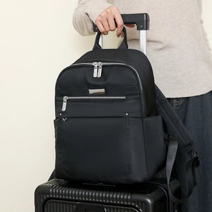 Detail of travel backpack with luggage strap secured to a trolley case handle