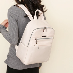 Waterproof nylon backpack for women in cream beige showing back-carrying size and fit