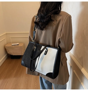 Close-up of contrast large tote bag in black and white canvas with leather handles